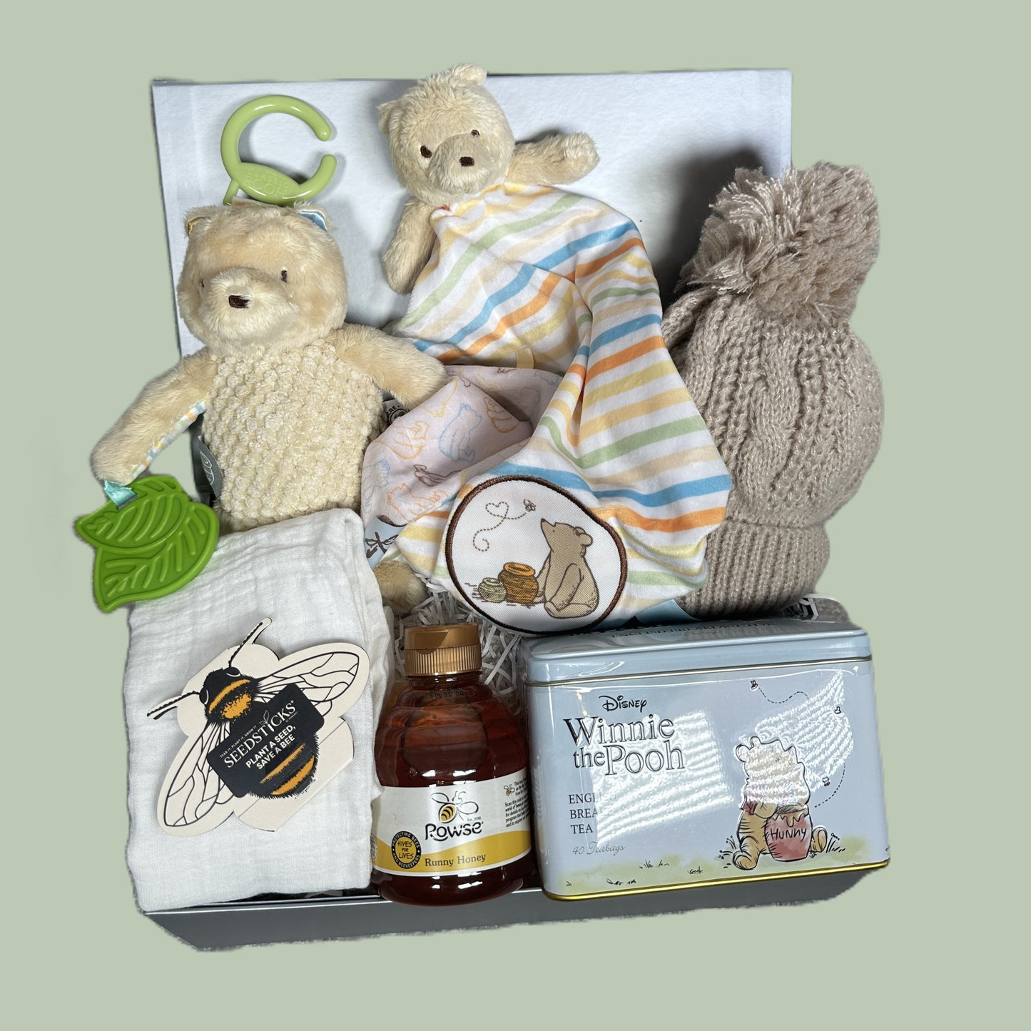 Winnie the pooh themed new baby gift hamper with toys, tea and honey