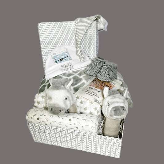 This zebra themed baby hamper comes in a grey and white  baby keepsake box and contains 2 soft zebra baby rattles, a grey baby blanket with a grey and white giraffe pattern, a pair of grey baby booties, a wish bracelet, a baby grey knot hat and a white cotton baby hat along with 2 baby muslin squares.