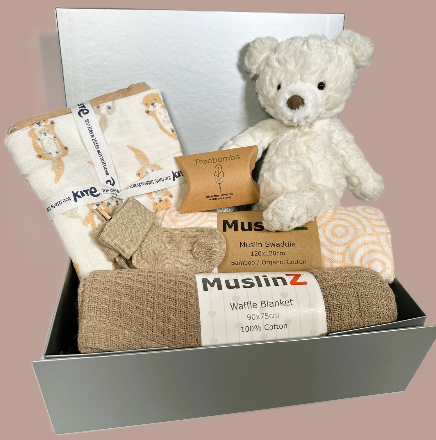 New baby girl hamper in a sliver coloured baby keepsake box which contains a Mary Meyer cream teddy bear, a muslins baby swaddle and baby blanket.  3 organic cotton baby muslins, one with an otter print.