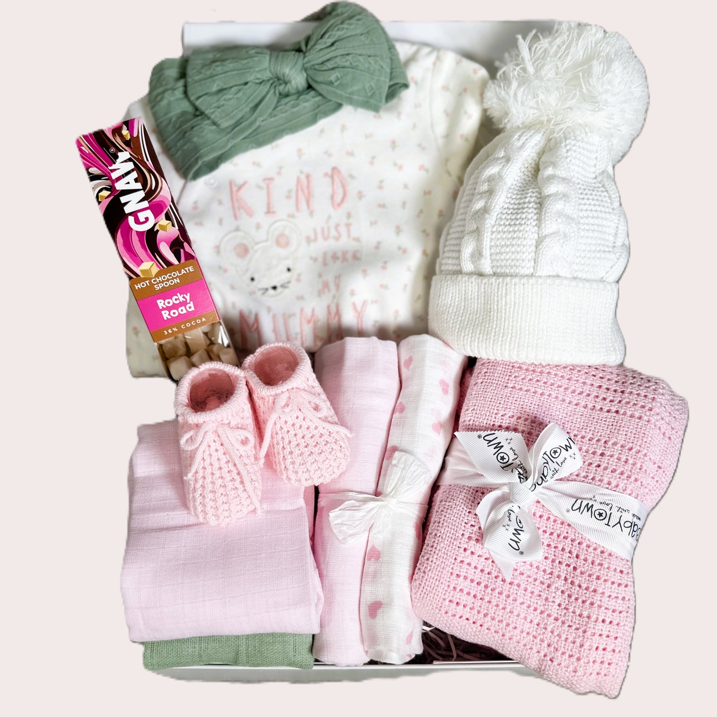 Baby Girl hamper with sleepsuit green hairband white baby hat, pink blanket and pink booties