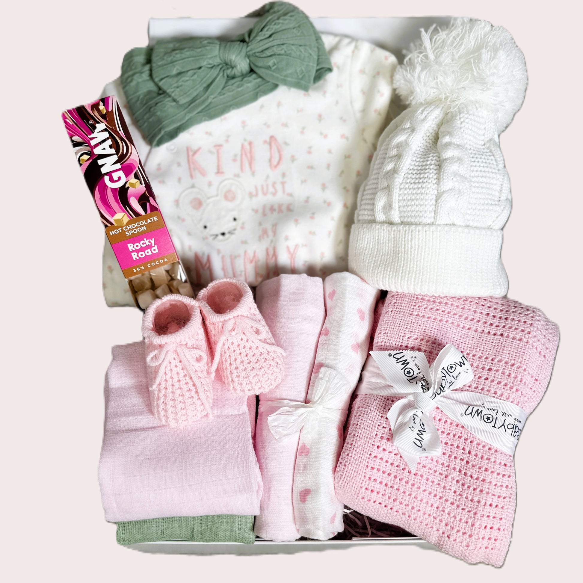 Baby Girl hamper with sleepsuit green hairband white baby hat, pink blanket and pink booties