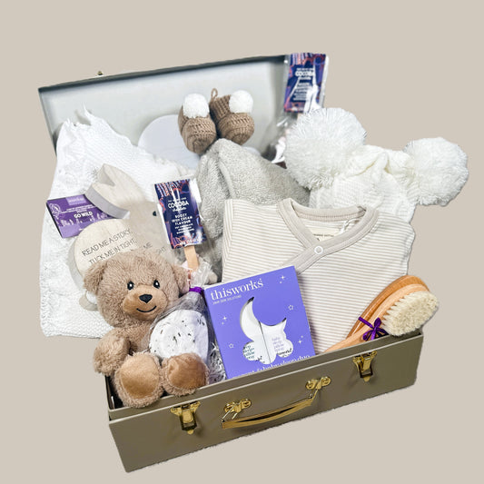 new baby hamper with baby clothes and baby blanket and chocolate