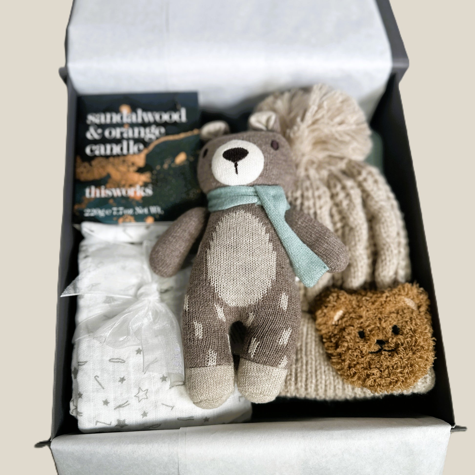 Gift set with knitted toys and baby items in a box