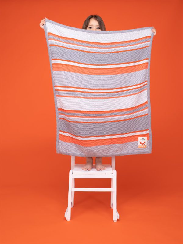 100% cotton baby blanket in grey with a lovely orange and white horizontal stripe.