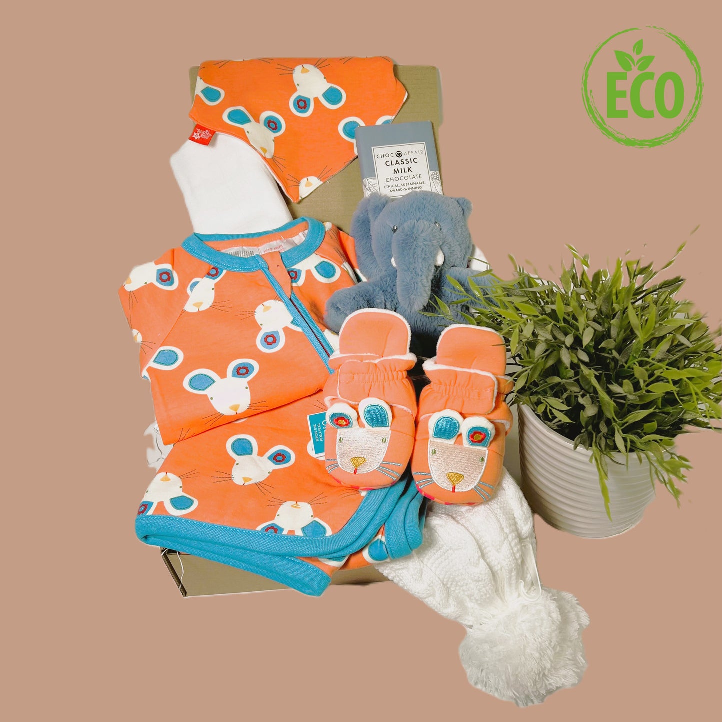 Eco Friendly new baby girl gift hamper containing a Blade and rose cotton romper, bib , baby blanket and slipper for the Maura Mouse range, plus a baby pompom hata large white muslin square, a bar of Choc Affair sustainably sourced chocolate and a Keeleco Ezra elephant baby comforter.