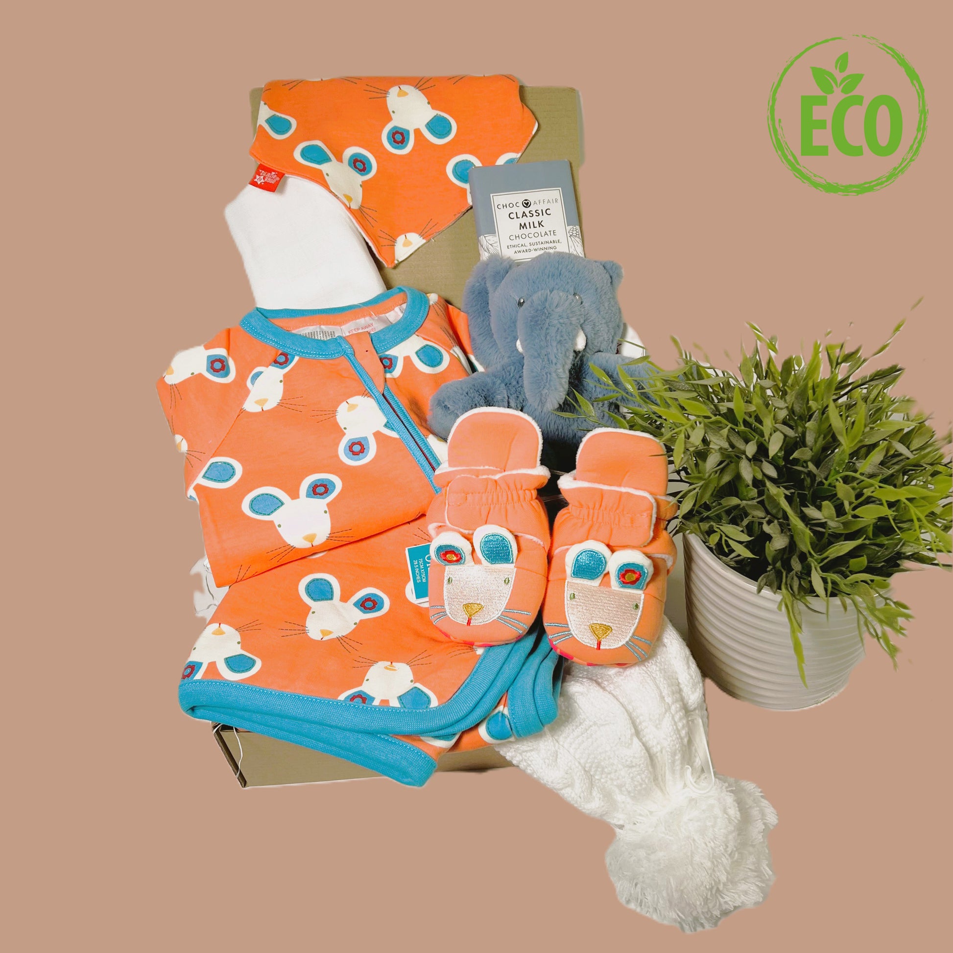 Eco Friendly new baby girl gift hamper containing a Blade and rose cotton romper, bib , baby blanket and slipper for the Maura Mouse range, plus a baby pompom hata large white muslin square, a bar of Choc Affair sustainably sourced chocolate and a Keeleco Ezra elephant baby comforter.
