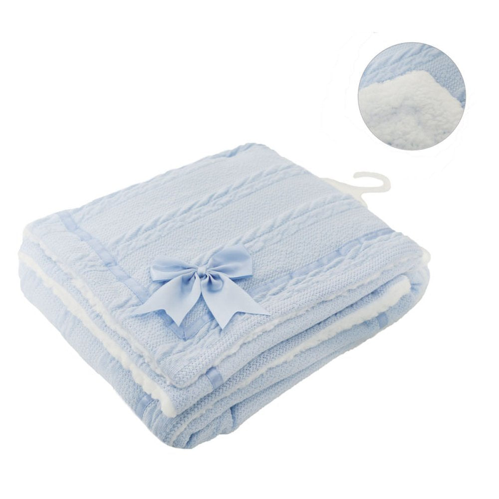 Light blue baby blanket with a bow on a white background