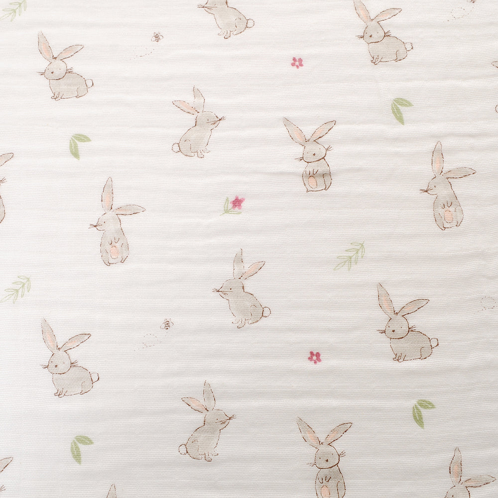 Pattern of cartoon bunnies and flowers on a white background