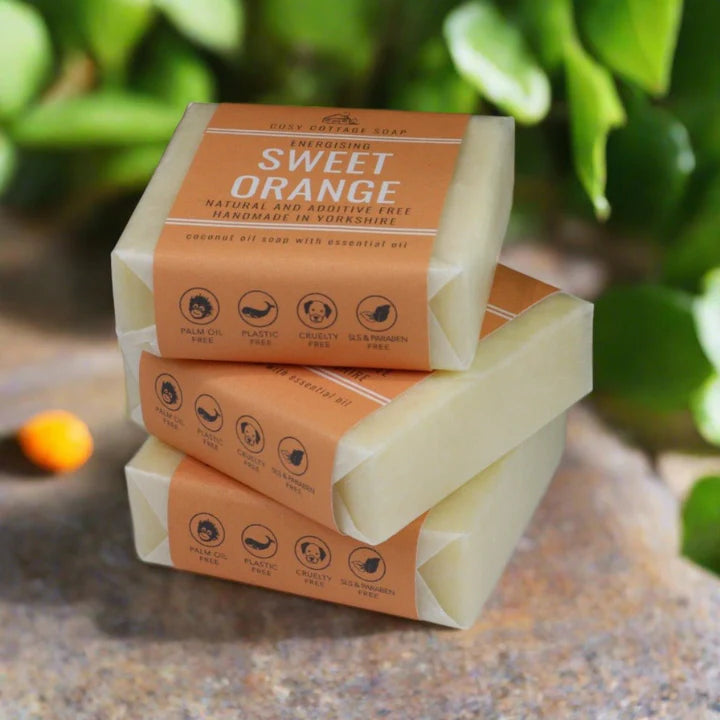Three stacked bars of soap in a 'Sweet Orange' natural soap.