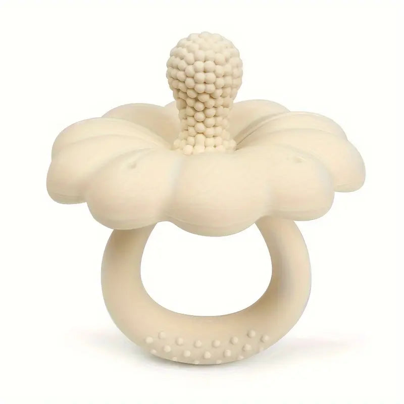 Beige silicone teething ring with textured design on a white background