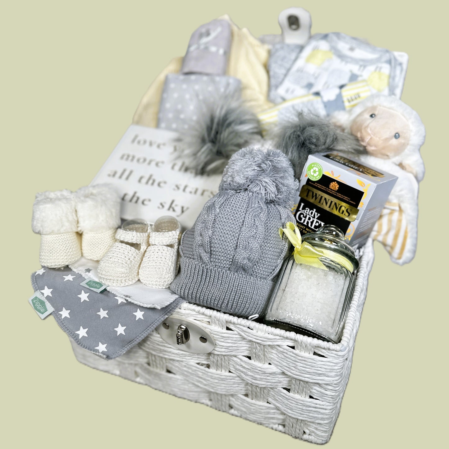 Baby Gift hamper basket with baby clothes, baby soft toy, tea, baby blanket and baby shoes.