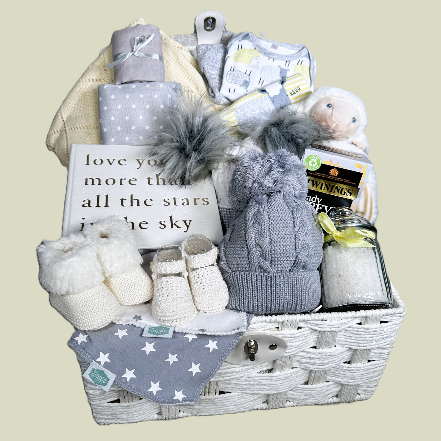 Baby Gift hamper basket with baby clothes, baby soft toy, tea, baby blanket and baby shoes.