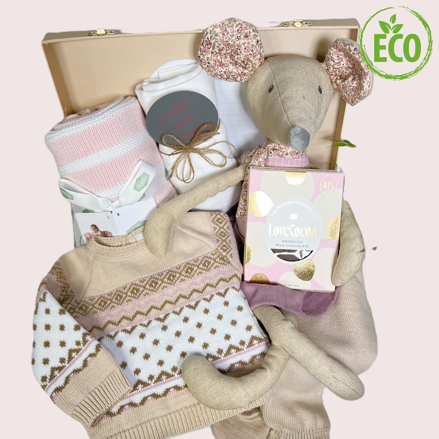 This baby girl gift contains a fine knit cotton Fair aisle 2 piece baby clothing set, a cotton baby blanket in pink and white stripes, a muslin sqaure, a bar of presecco chocolate, a photography disc and a large linen mouse toy.