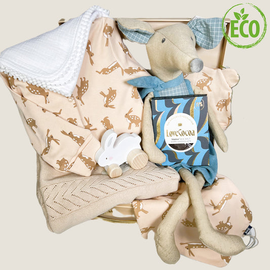 Luxury new baby boy gift in a card suitcase containing a 50cms linen mouse toy dressed in blue corduroy shorts and matching neck scarf, a neutral 100% cotton baby blanket, a white baby muslin with pompom trim, a wooden push along rabbit toy,an organic cotton baby blseepsiuit with an adorable hare print , matching hat and baby bib. A bar of Love Cocoa Malvern sea salt chocolate