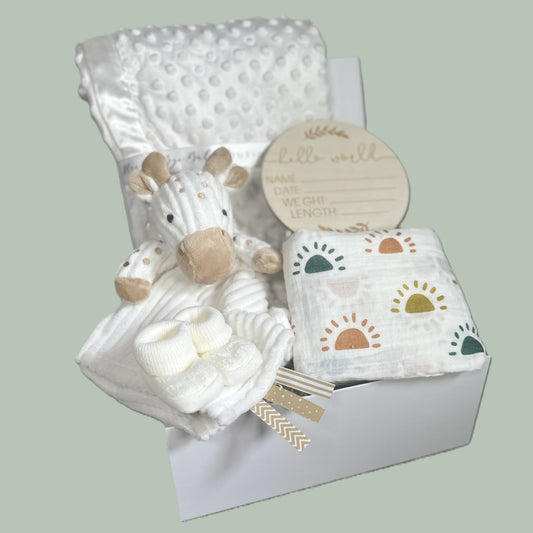 Baby gift set with plush toy giraffe comforter white baby, blanket, and muslin square in a baby keepsake box on a light green background