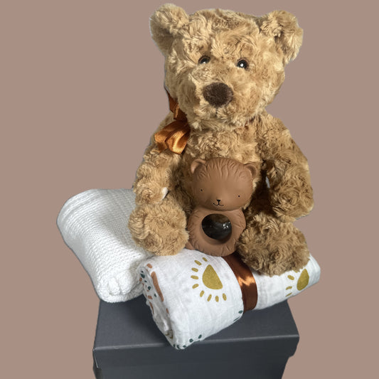 new baby gift with a teddy, a natural rubber bear teether a white cotton baby blanket and a sundshine print baby swaddle blanket.