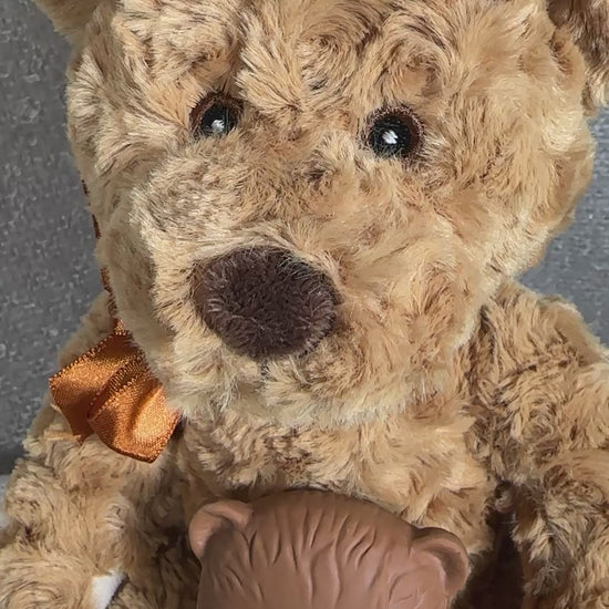 video of a new baby gift box with teddy , bear teether, muslin and a white cellular baby blanket in a grey baby keepsake box.