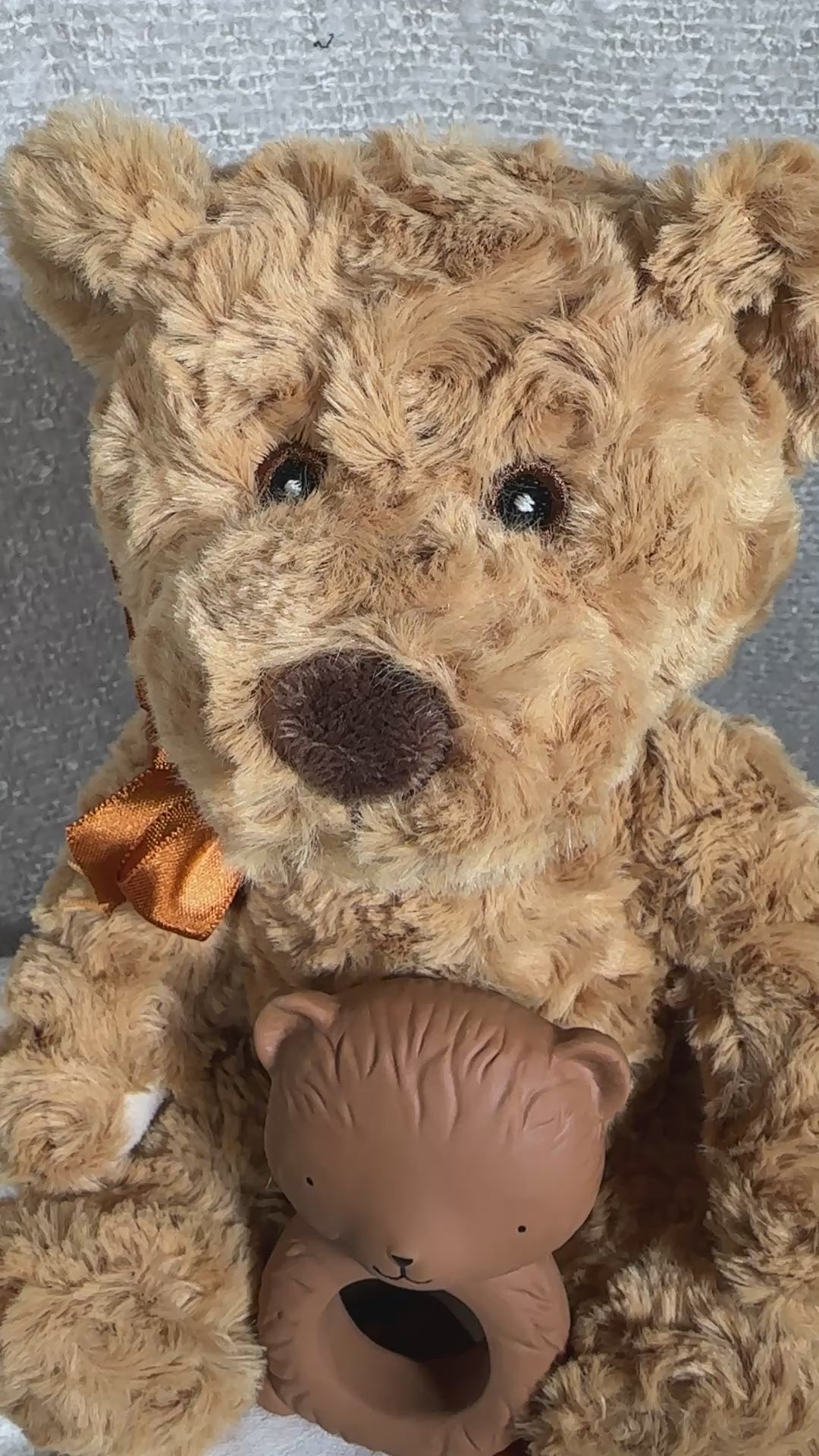 video of a new baby gift box with teddy , bear teether, muslin and a white cellular baby blanket in a grey baby keepsake box.