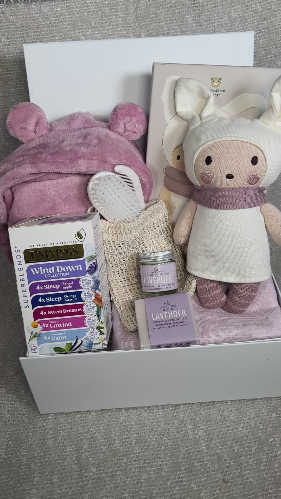 video of a baby Girl hamper with knitted doll and baby dressing gown
