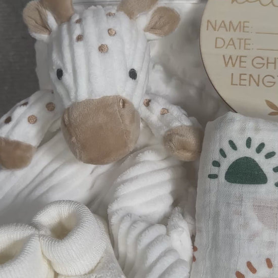 video of a baby hamper gift with giraffe baby comforter