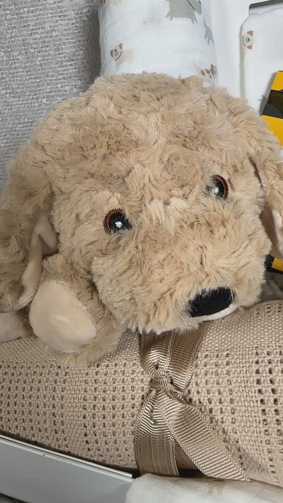 Video of a unisex baby Hamper with plush dog toy, baby blanket, burp cloths and security blankets