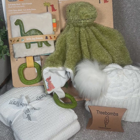 video of a dinosaur themed baby hamper with green dinosaur baby comforter and sensory baby book
