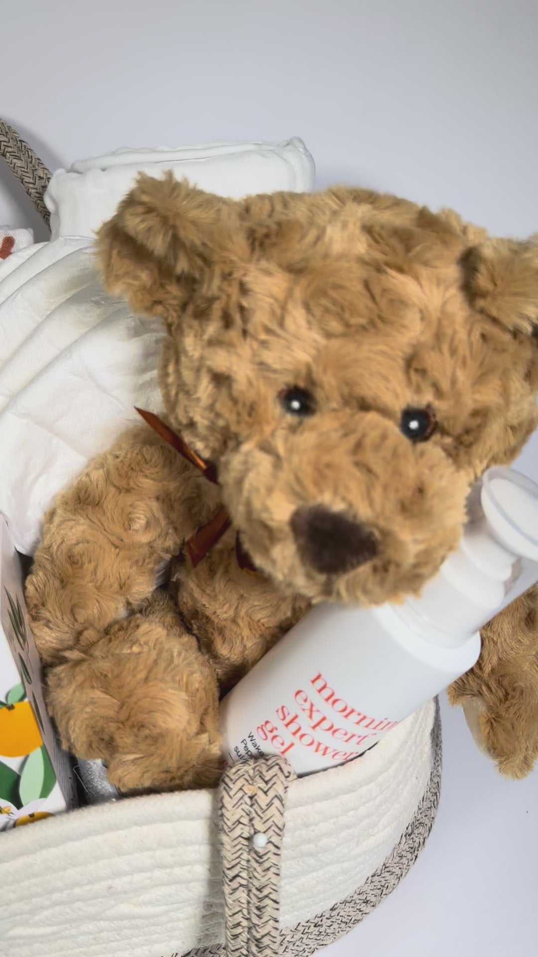 video of a baby gift basket with teddy bear, blanket, candle, shower gel.
