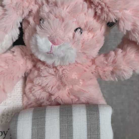 video - new baby gift box with pink bunny and white baby pompom hat.