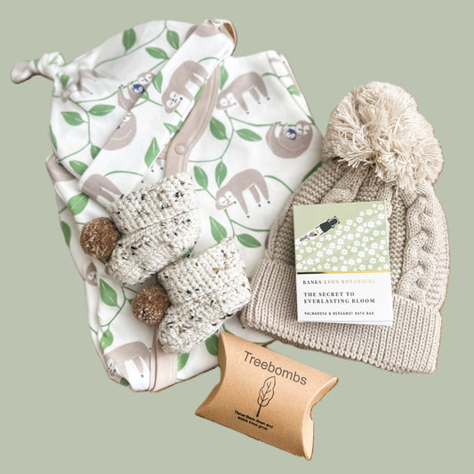 Neutral baby hamper gift with sloth print baby grow and hat and taupe baby pompom hat and baby booties