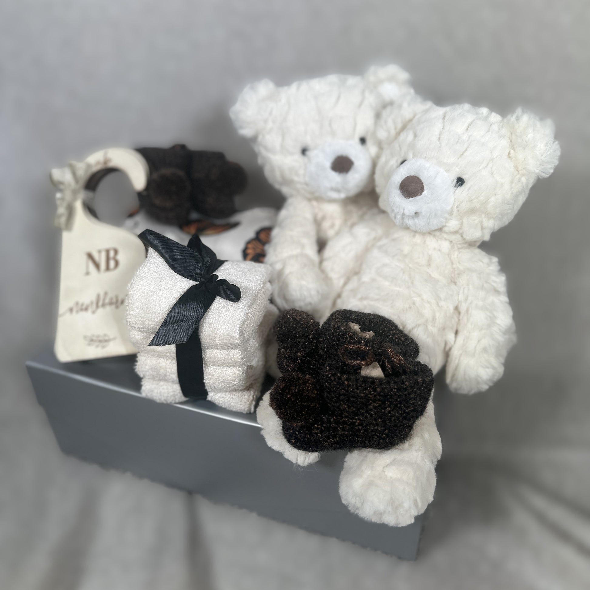 Twins baby hamper with butterfly print rompers and Mary Meyer teddy bears.