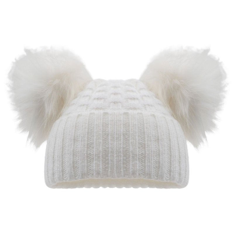 White knit beanie with two fluffy pom-poms on a white background