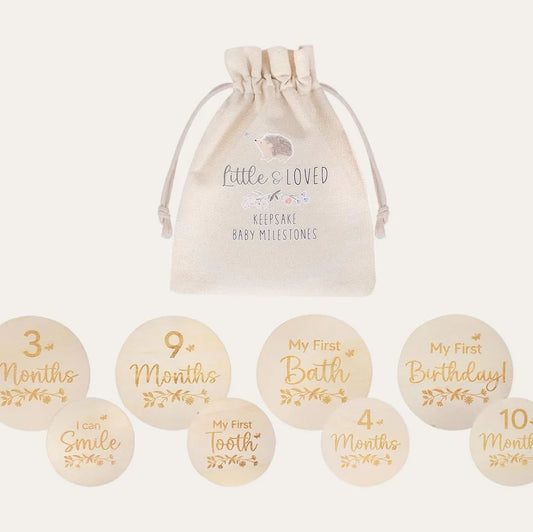 Set of baby milestone wooden discs with a drawstring bag on a white background