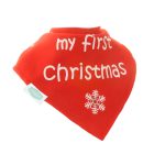 A red cotton baby dribble bib which reads "my first Christmas"