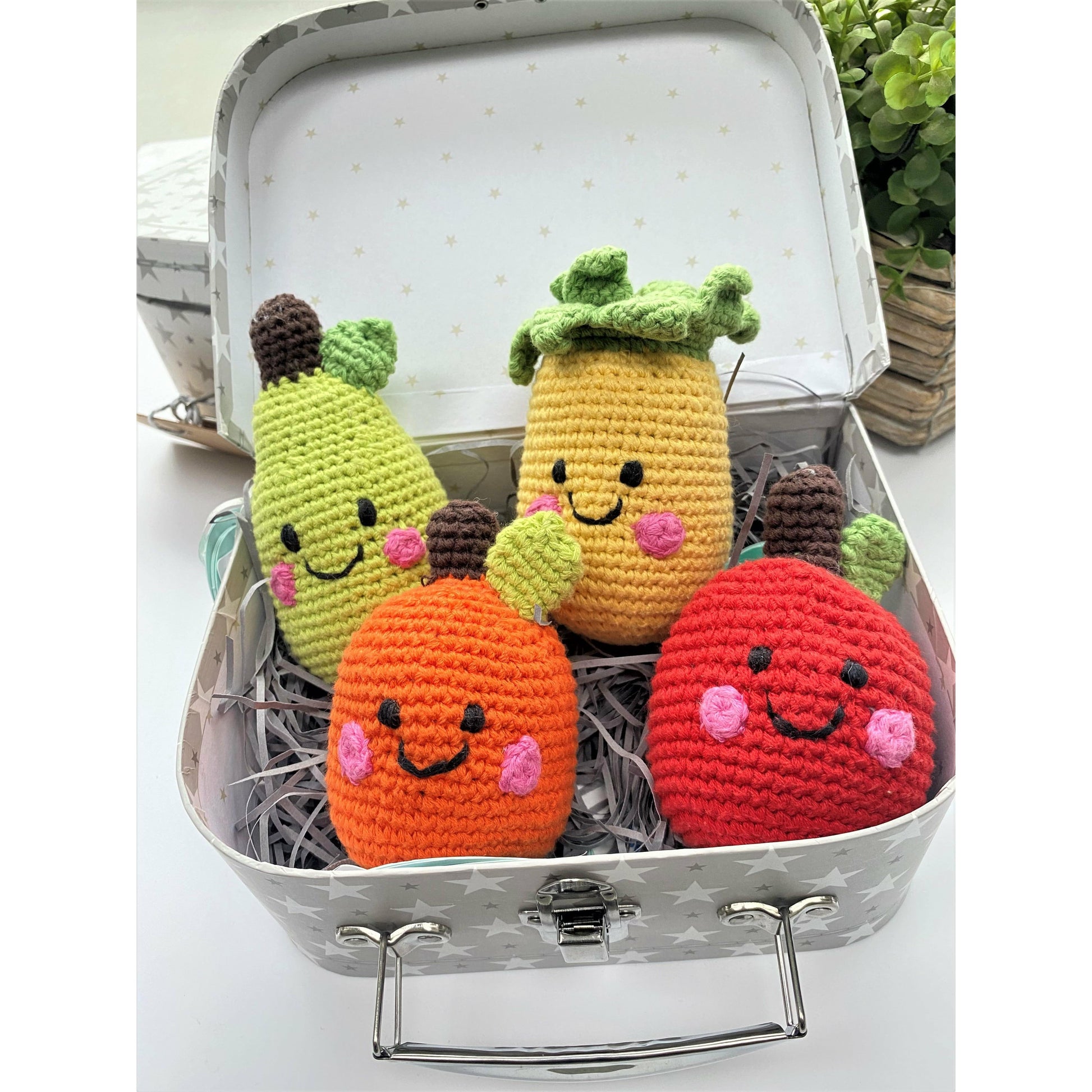 Cute chrocheted fruit baby rattles. An orange, an apple, a pear and a pineapple.