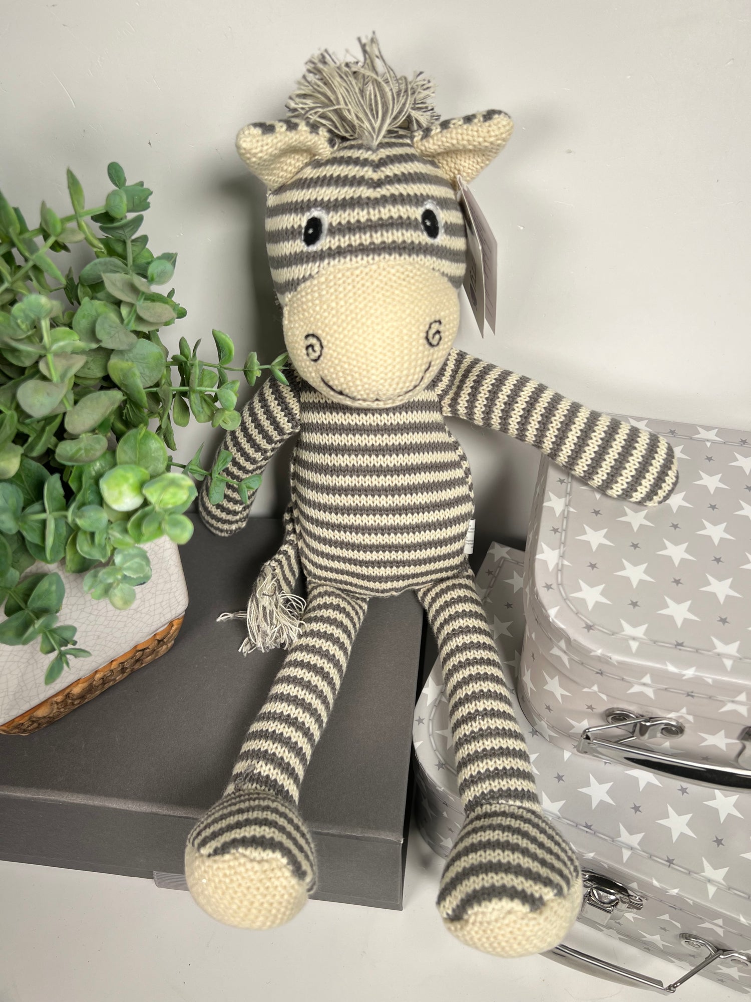 Zebra soft baby toy with an embroidered face.