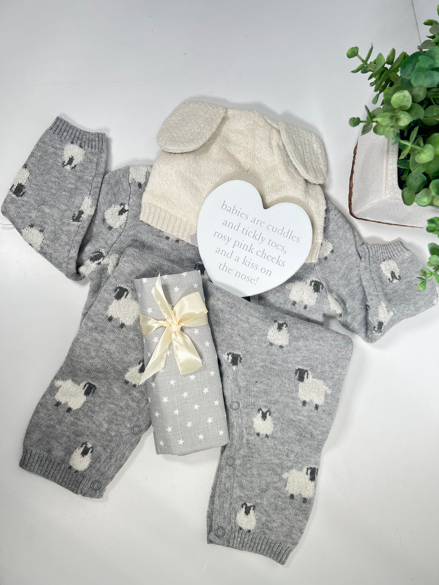 grey and white knitted lamb baby romper  with a cream lamb ear bay hat